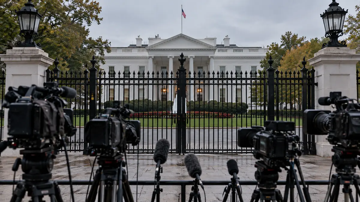 Closed White House gate with news cameras outside as the White House blocks CNN reporters